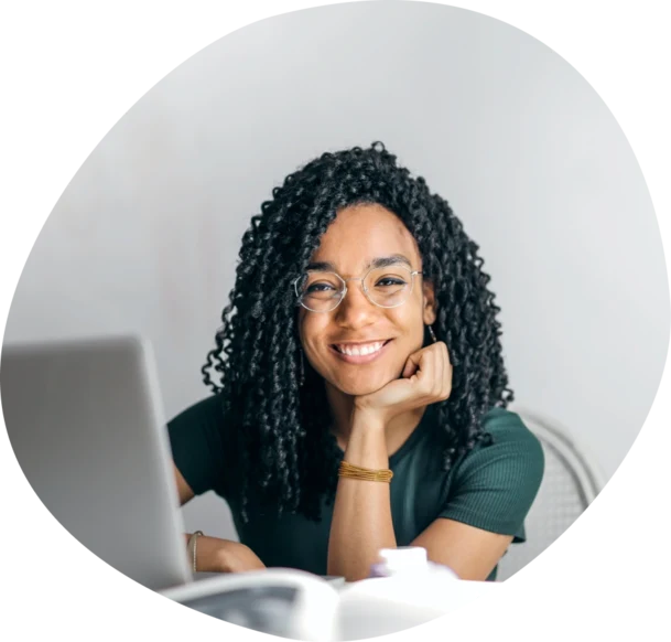 lady smiling with a laptop in front of her