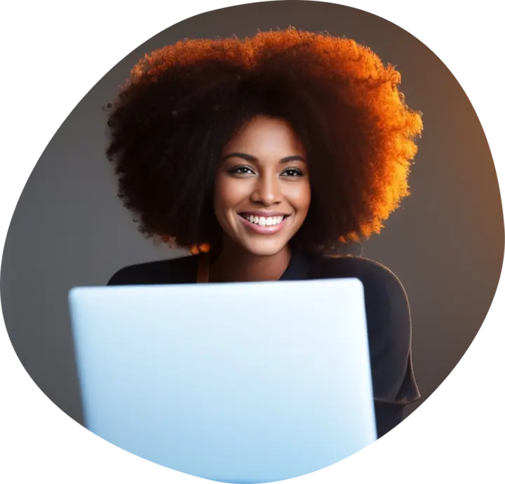 lady smiling with a laptop in front of her